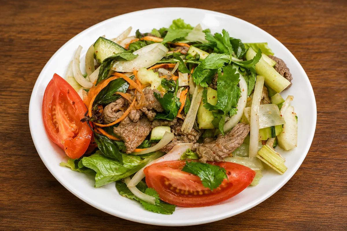 Spicy beef salad with tomatoes and fresh herbs